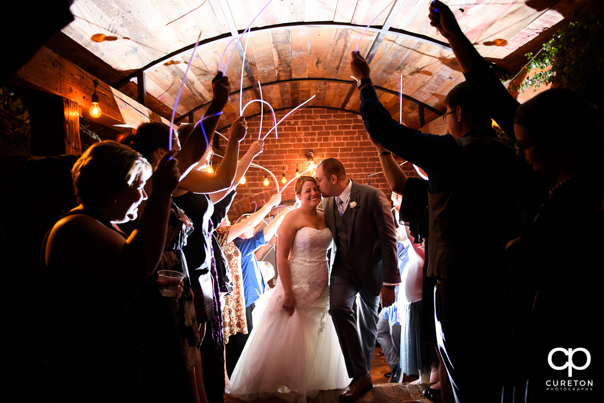 Bride and Groom making an epic grand exit through glow sticks at The Old Cigar Warehouse.