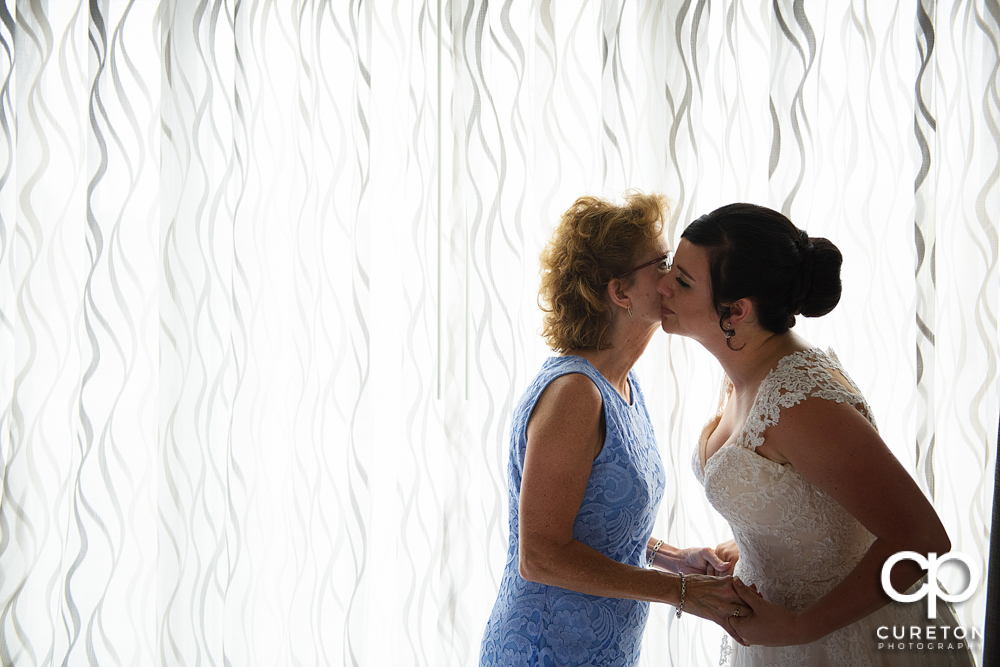 Bride and her mother sharing a moment before the wedding.