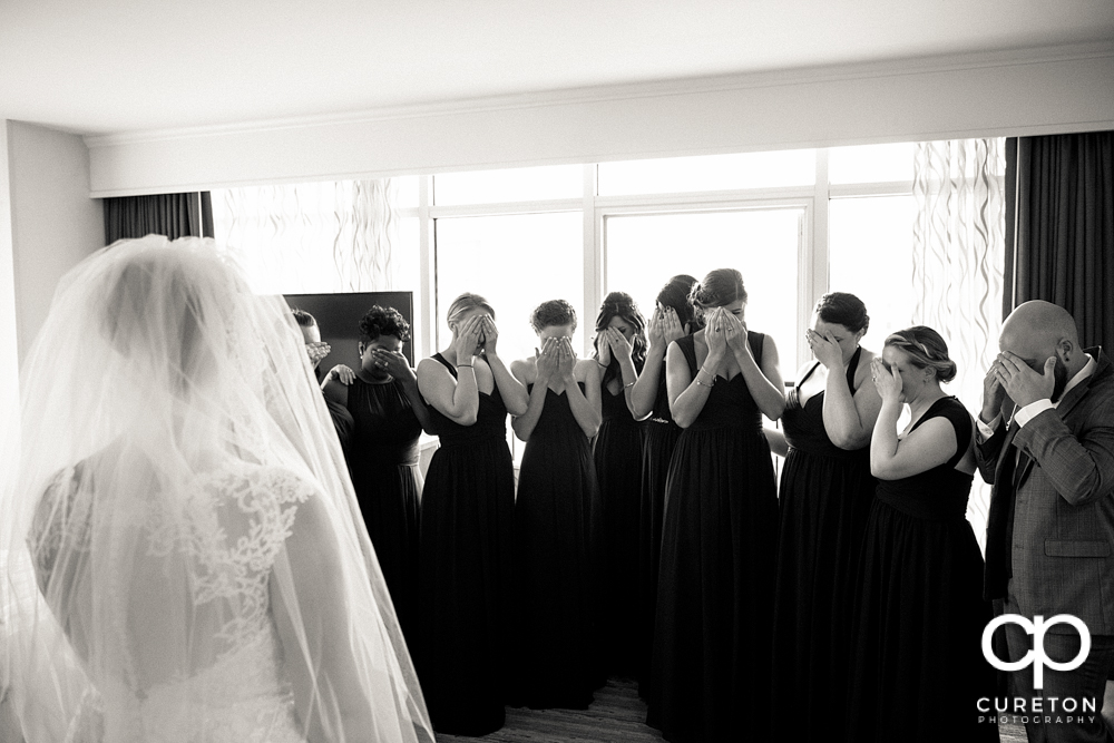 Bridesmaids prepared to see the bride for the first time.