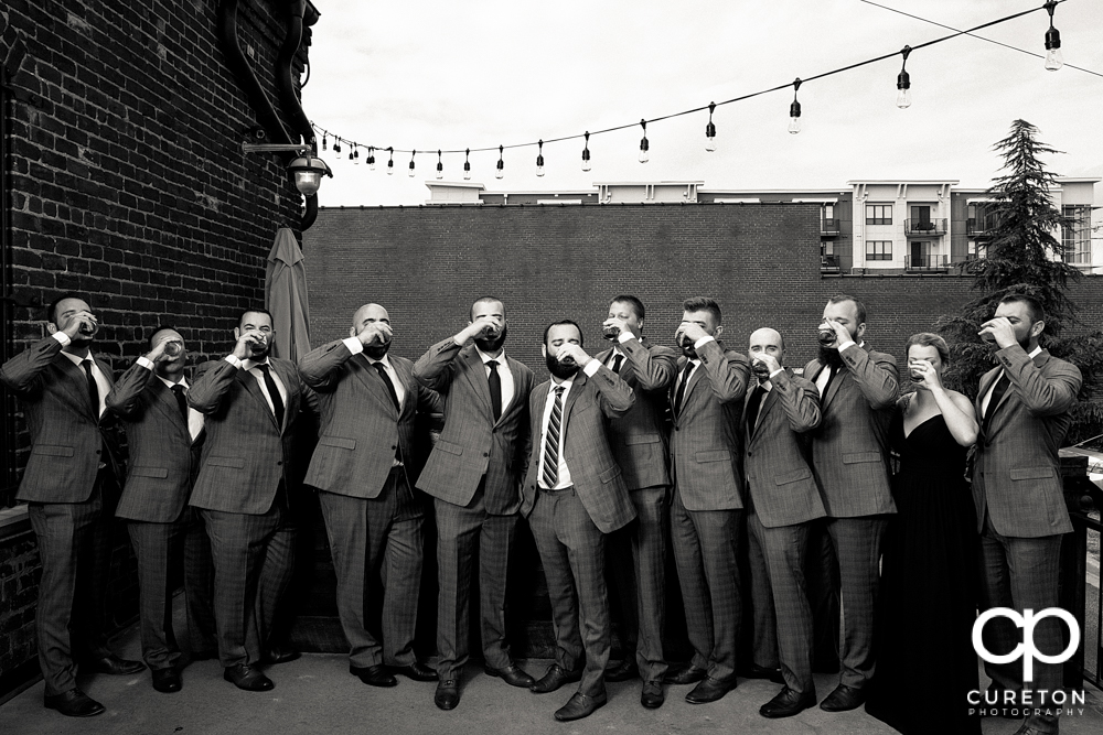 Groom and groomsmen having a pre-wedding drink.