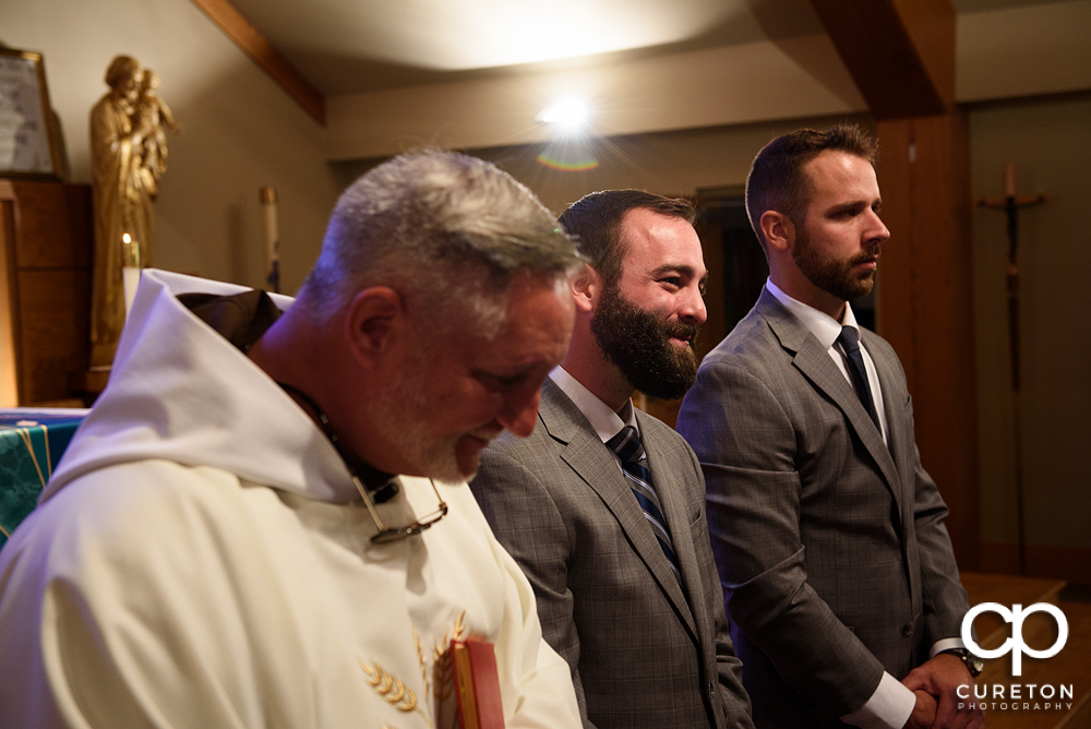 Groom sees his bride walking down the aisle.