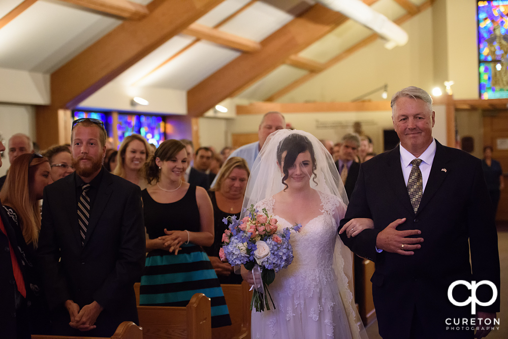 Bride walking down the aisle at Saint Anthony's downtown.