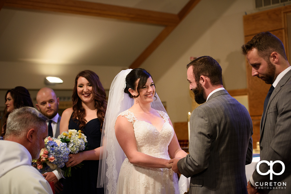 Bride smiling at her Groom during the wedding ceremony.
