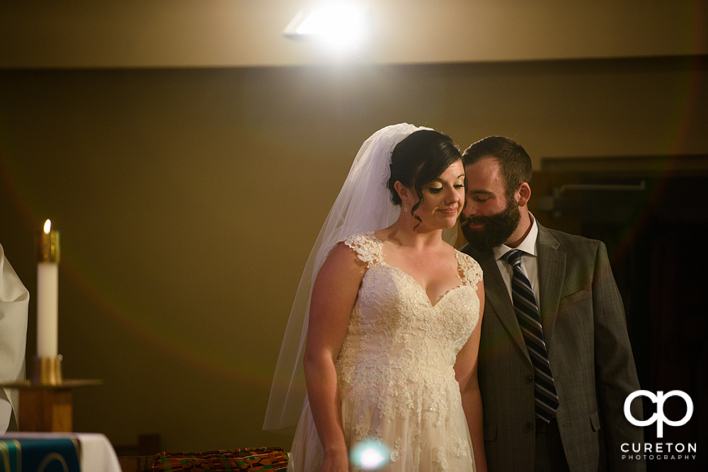 Bride and groom during their Catholic wedding ceremony in Greenville.