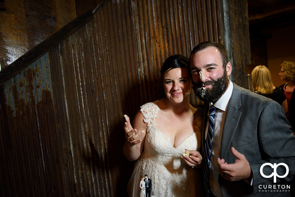 The bride and groom with cake on their faces.