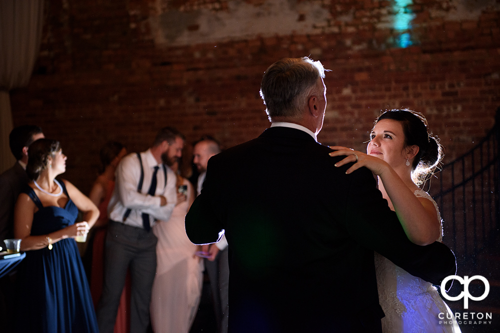 The bride and her father having a dance at her wedding reception.