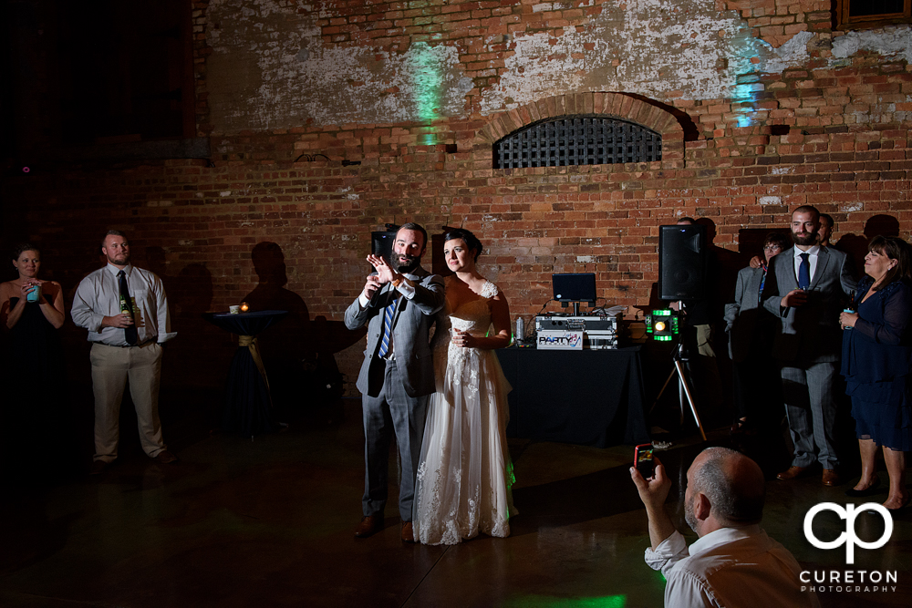 The newly married couple welcomes their guest to the reception.