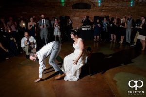 Groom dancing for the bride.