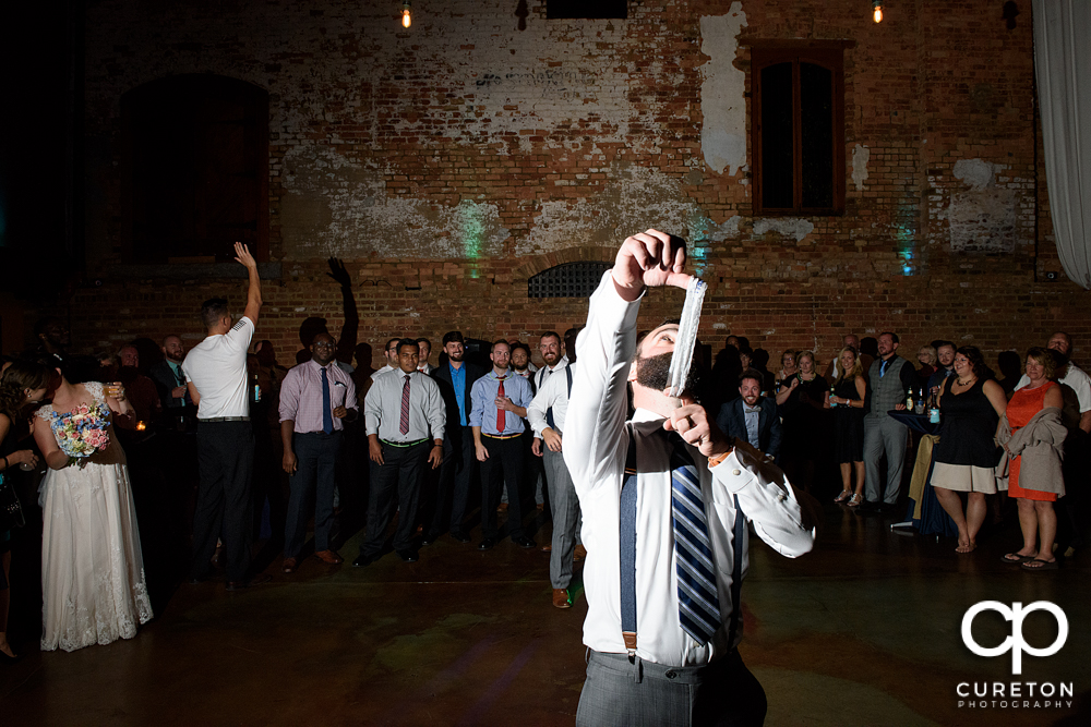 Groom tossing the garter.