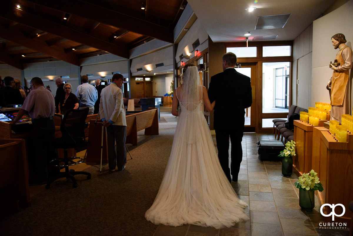 Bride walking with her dad down the aisle.