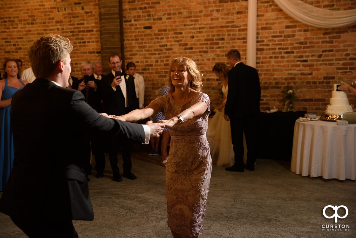 Groom and his mom sharing a dance at the wedding reception.