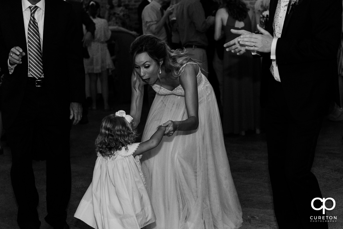 Bride dancing with the flower girl.
