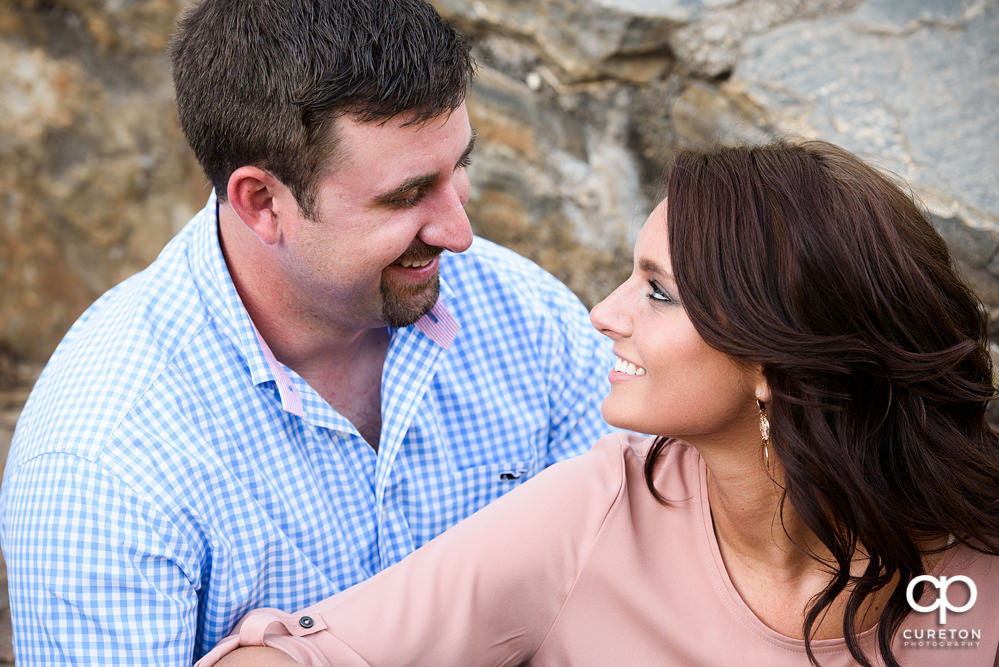 Engaged couple looking into each others eyes.