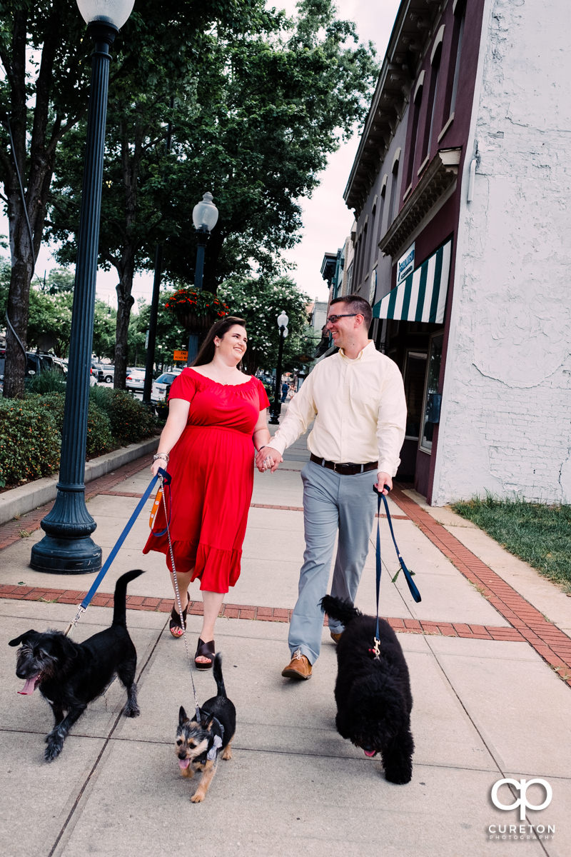 Engaged couple walking their dogs in downtown Greenville,SC.