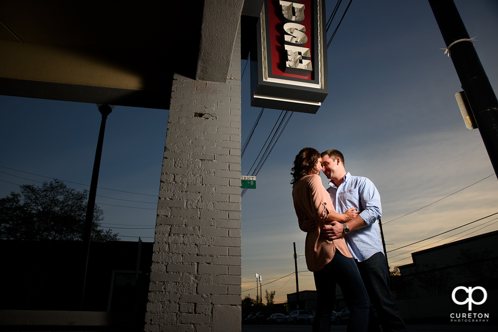 Future bride and groom at sunset during an engagement session in the west end area of downtown Greenville,SC.
