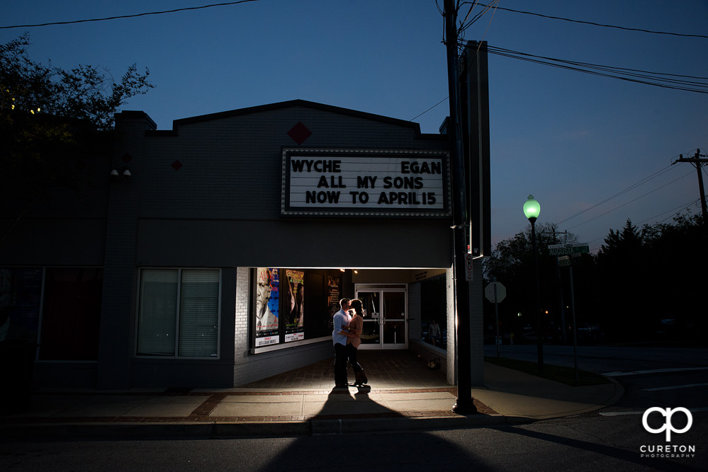 Engaged couple in front of the Warehouse Theatre in downtown Greenville SC.