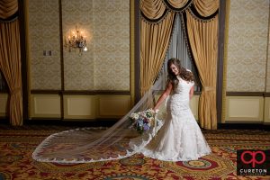 Bride with long veil in the Gold Room of the Westin Poinsett.