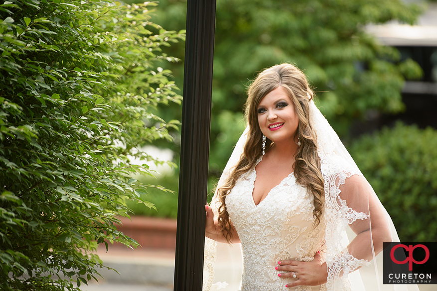 Bride near a lampost in downtown Greenville.