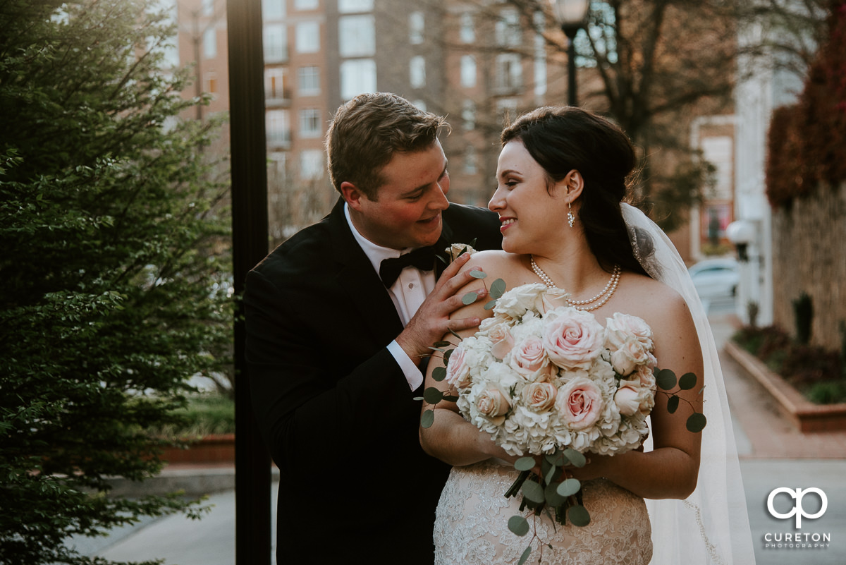 Bride and groom smiling at each other.