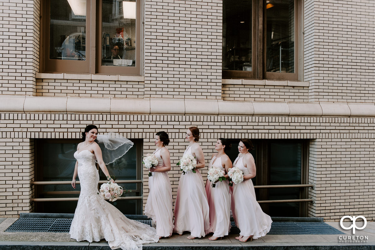 Bride and her bridesmaids on the streets of downtown Greenville.