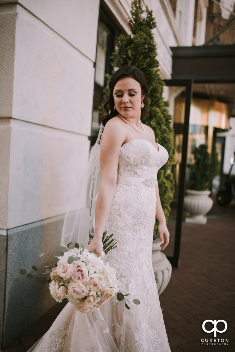 Bride standing on main street holding her bouquet before the ceremony at her Westin Poinsett Hotel Wedding in Greenville,SC.