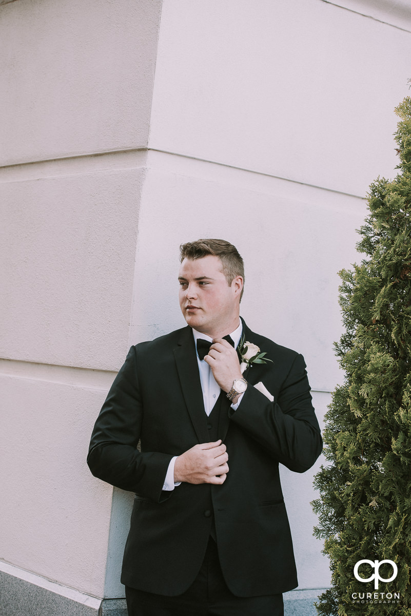 Groom adjusting his tie before his Westin Poinsett Hotel Wedding in Greenville,SC.