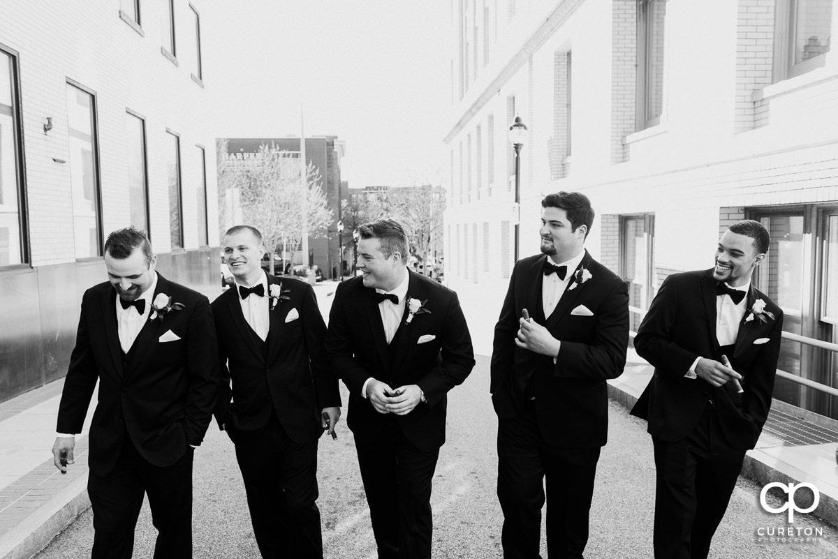 Groom and groomsmen laughing before the wedding.