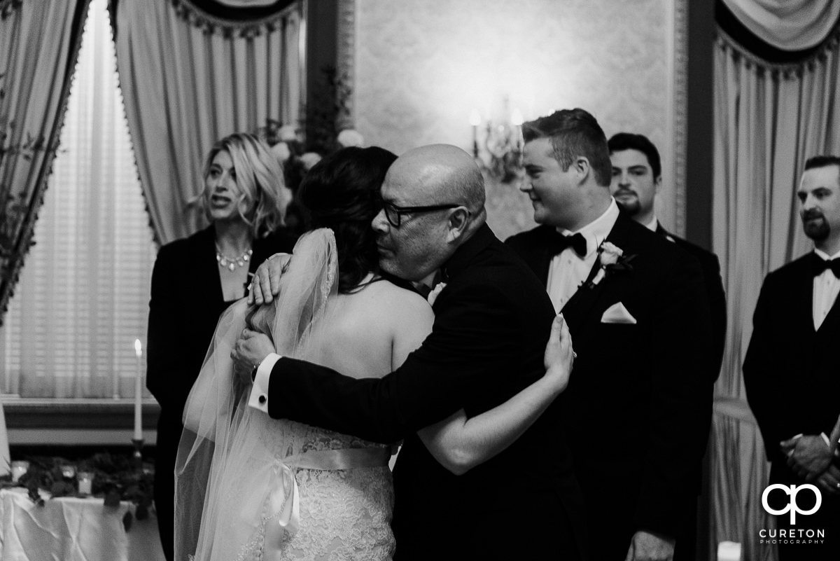 Bride hugging her father.