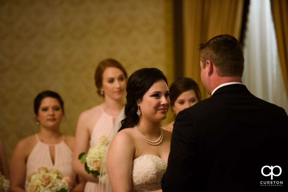 Bride smiling during the ceremony.