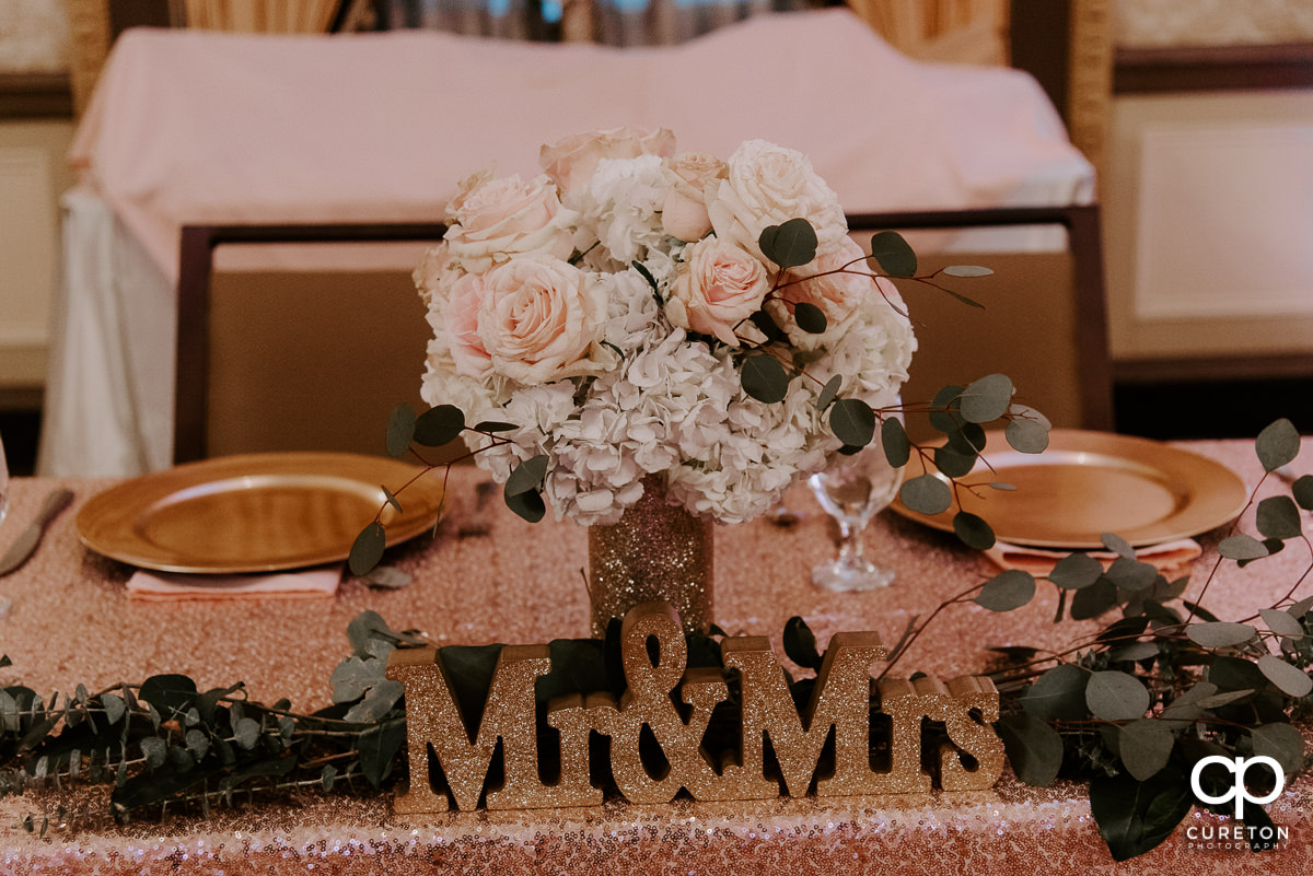 Floral arrangement next to the Mr. and Mrs. sign.