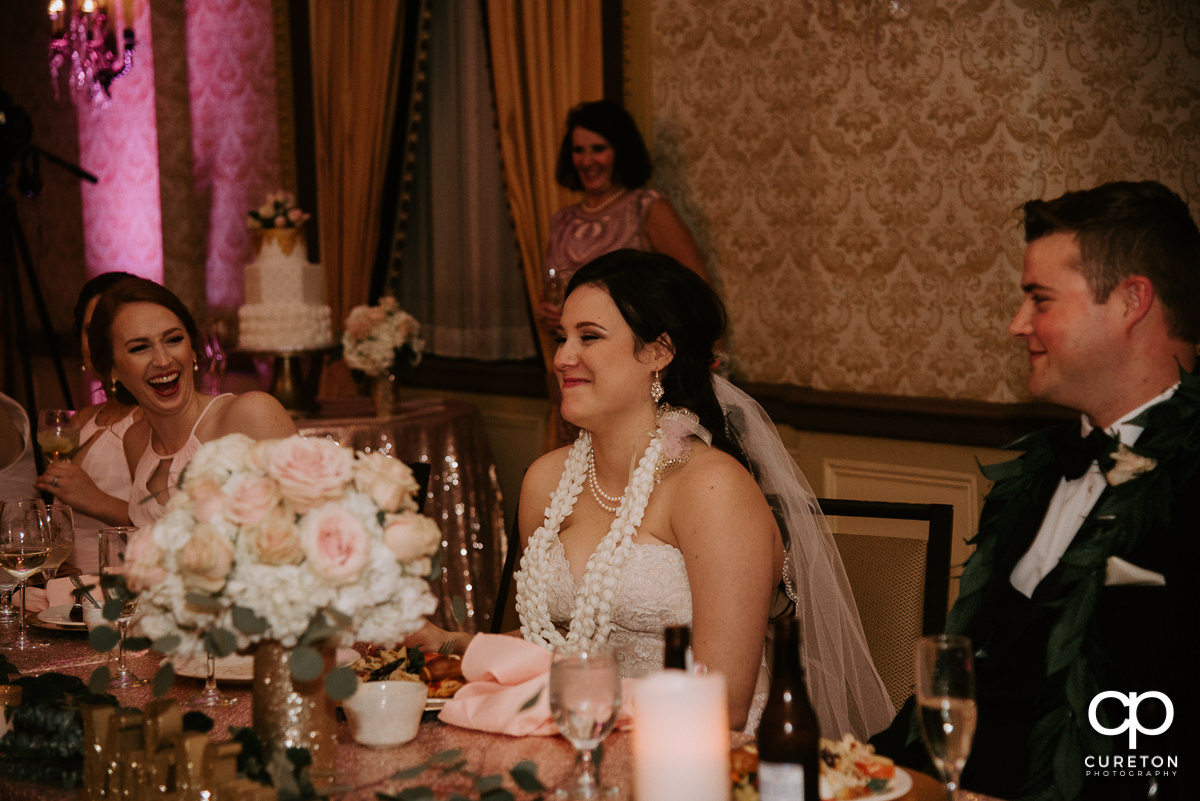 Bride laughing during the speeches.
