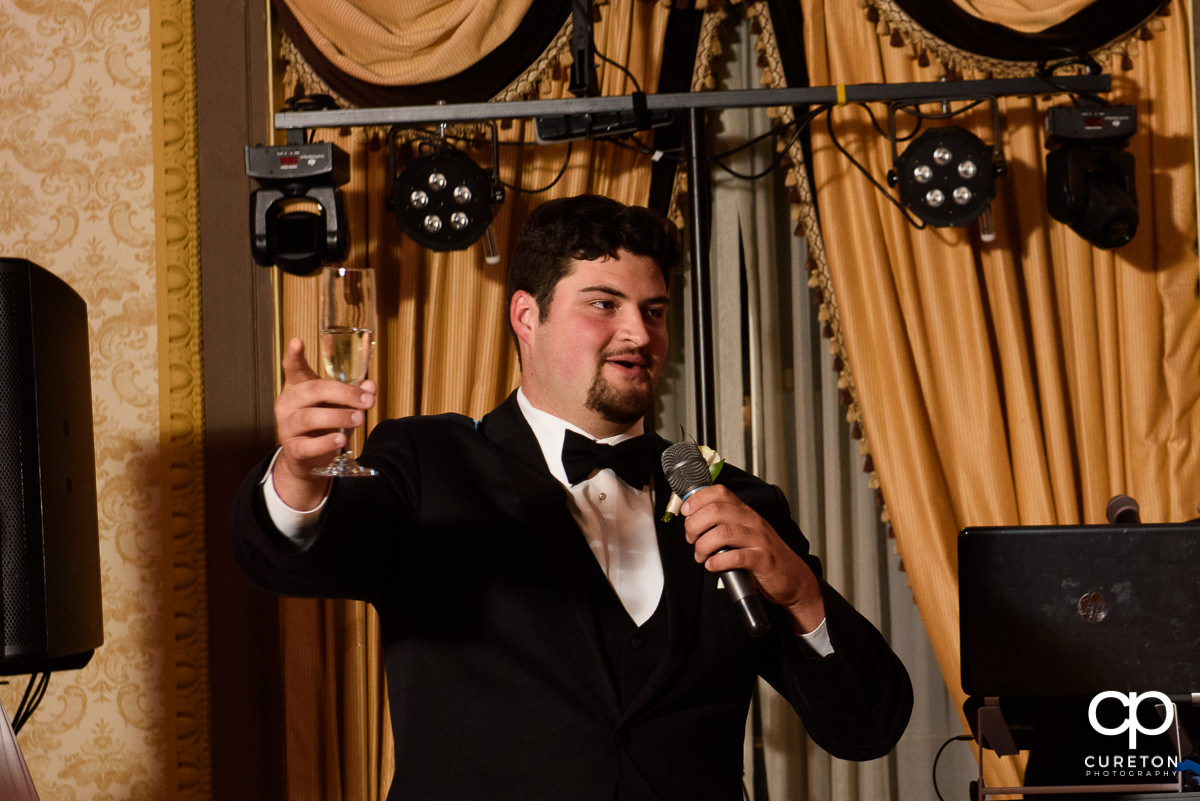 Groomsmen making a speech at the reception.