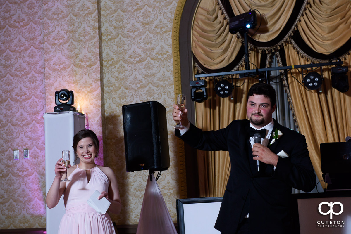 Bridesmaid and groomsmen making a speech at the wedding reception.