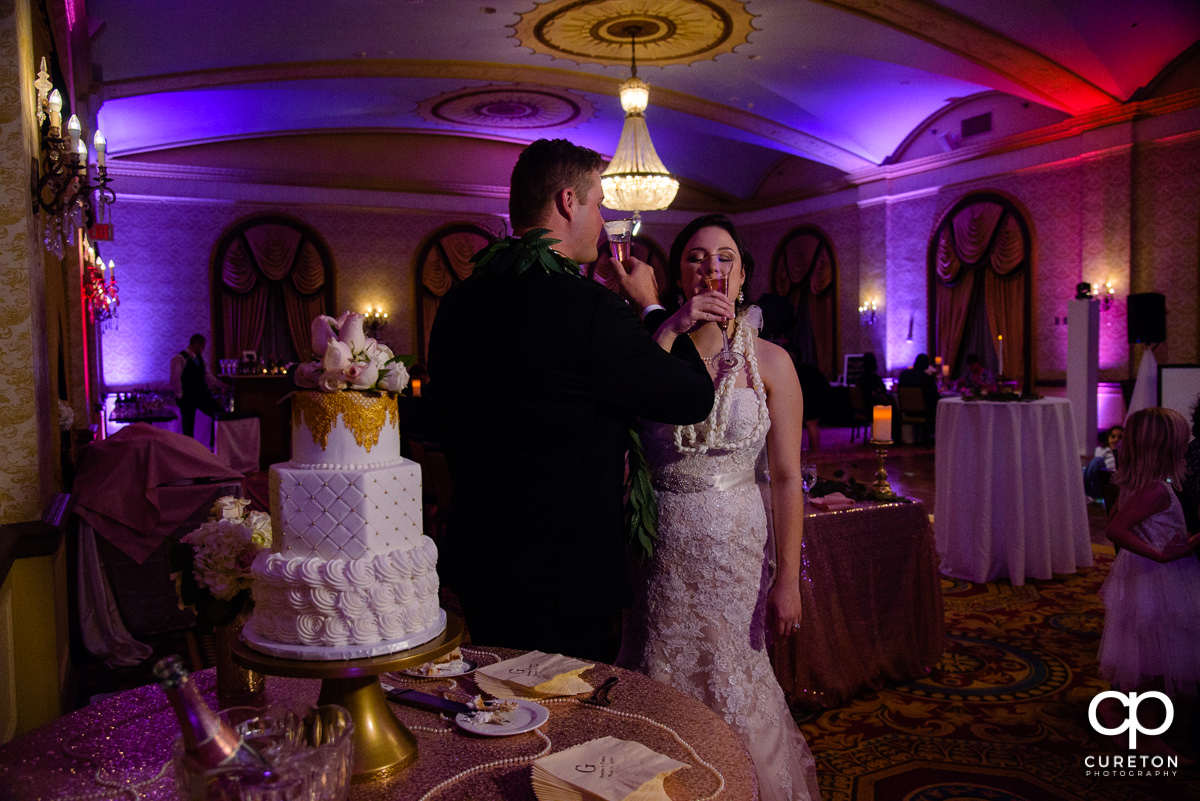 Bride and groom toasting in the gold room at The Westin Poinsett reception.