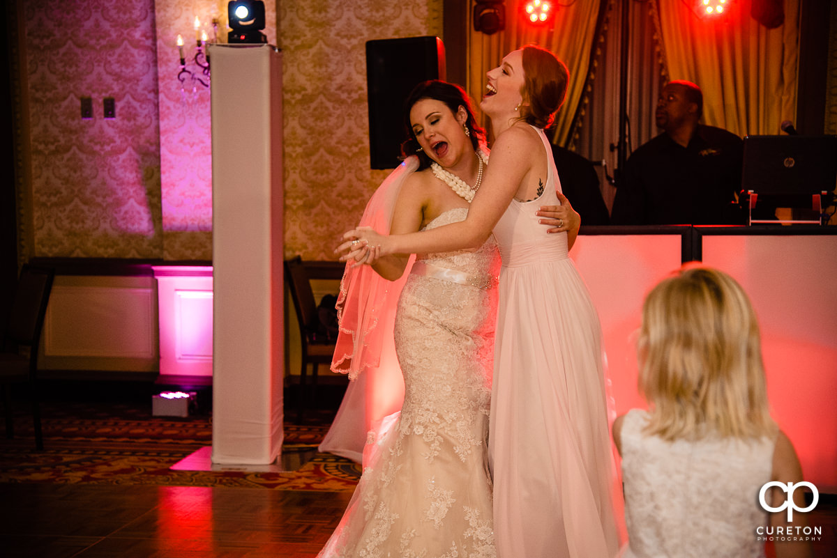 Bride and bridesmaids dancing.
