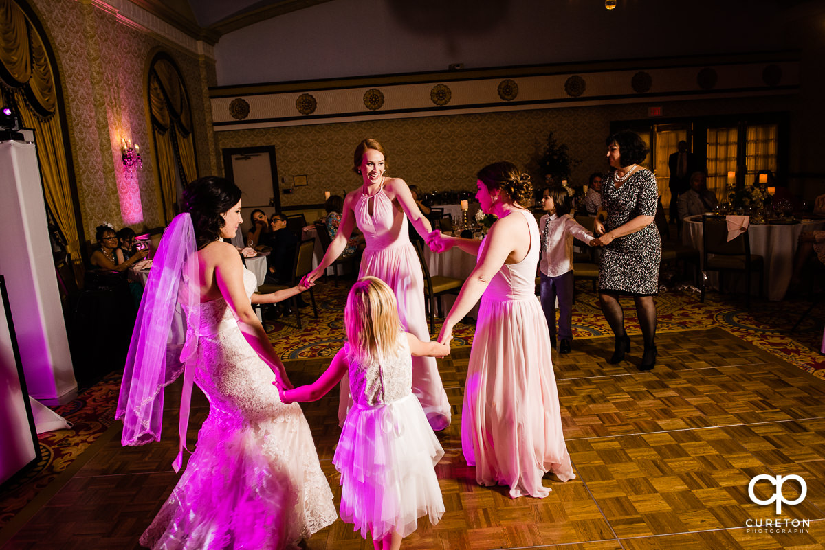 Bride and bridesmaids dancing on the dance floor.