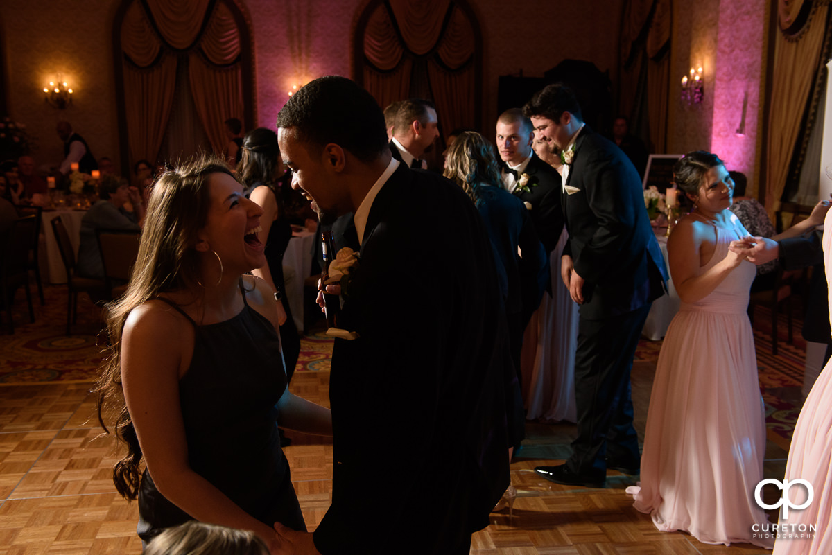 Wedding guests dancing at the wedding reception in the Gold Room of the Westin Poinsett Hotel.