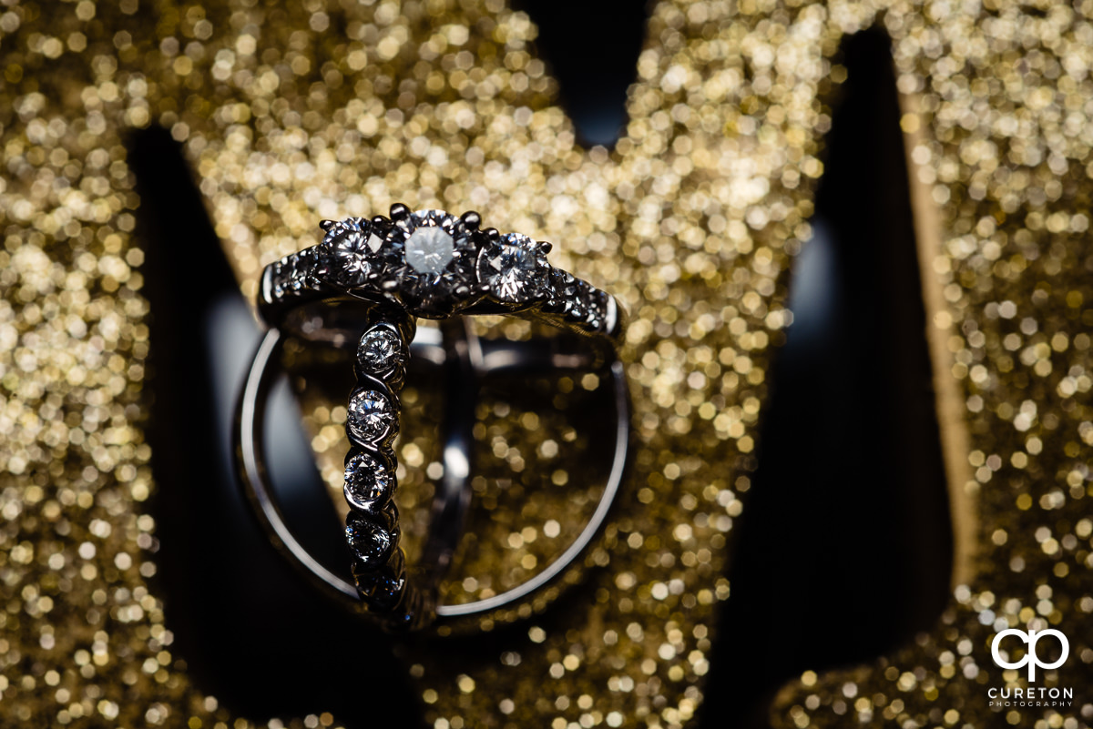 Wedding rings closeup on a glitter backdrop.