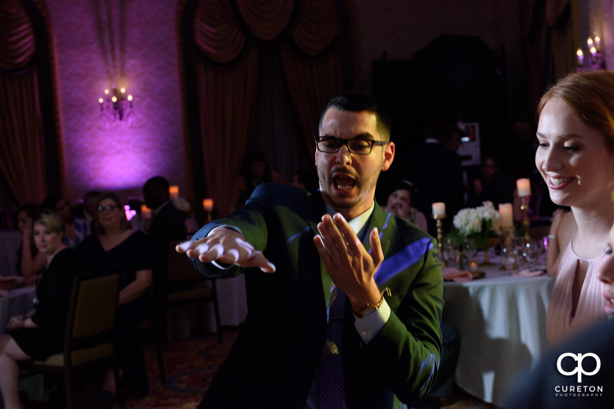 Wedding guests dancing at the wedding reception in the Gold Room of the Westin Poinsett Hotel.