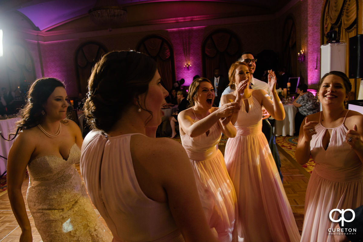 Wedding guests dancing at the wedding reception in the Gold Room of the Westin Poinsett Hotel.