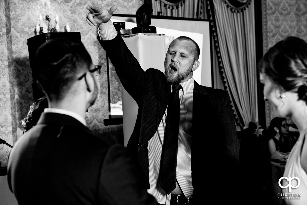 Wedding guests dancing at the wedding reception in the Gold Room of the Westin Poinsett Hotel.