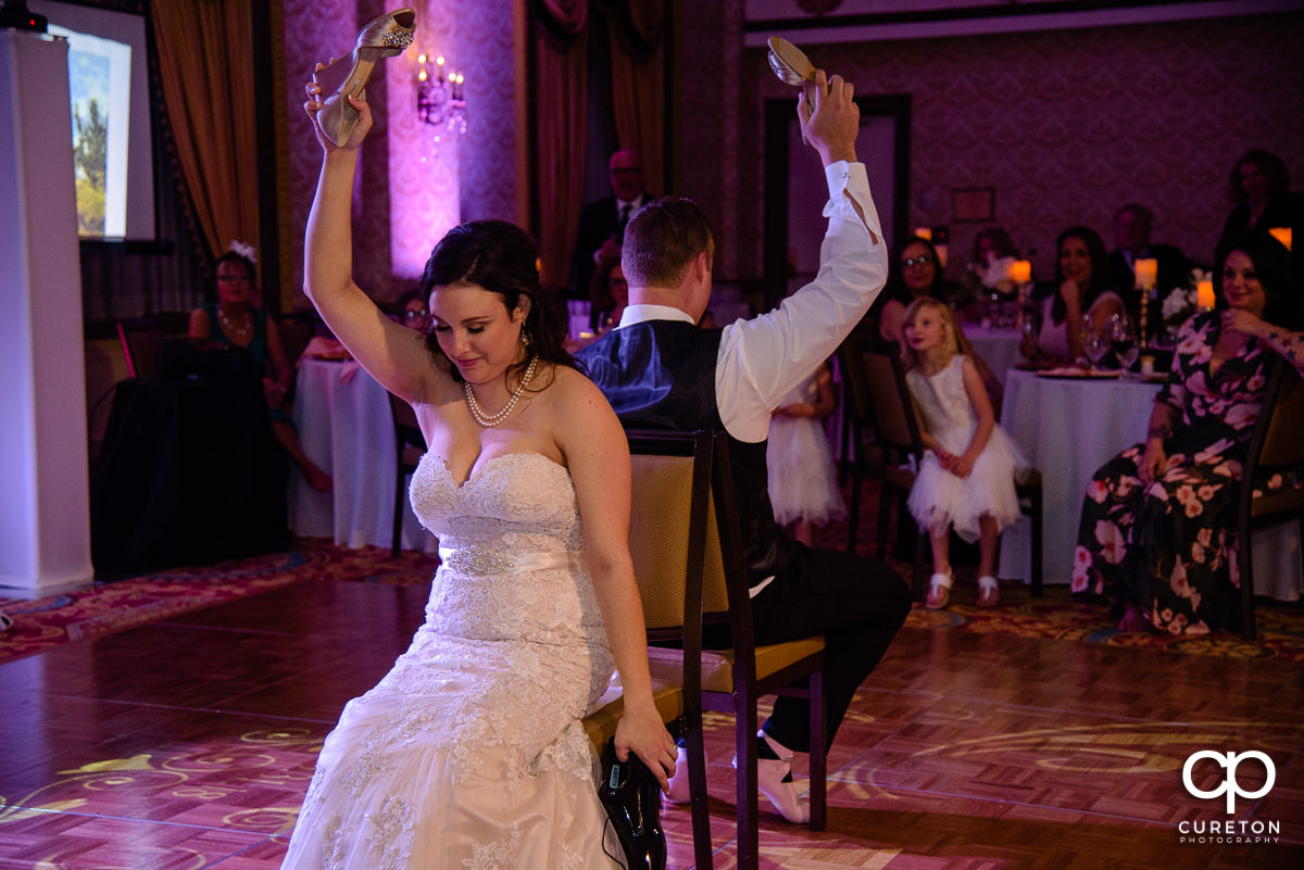 Bride and groom playing the shoe game.