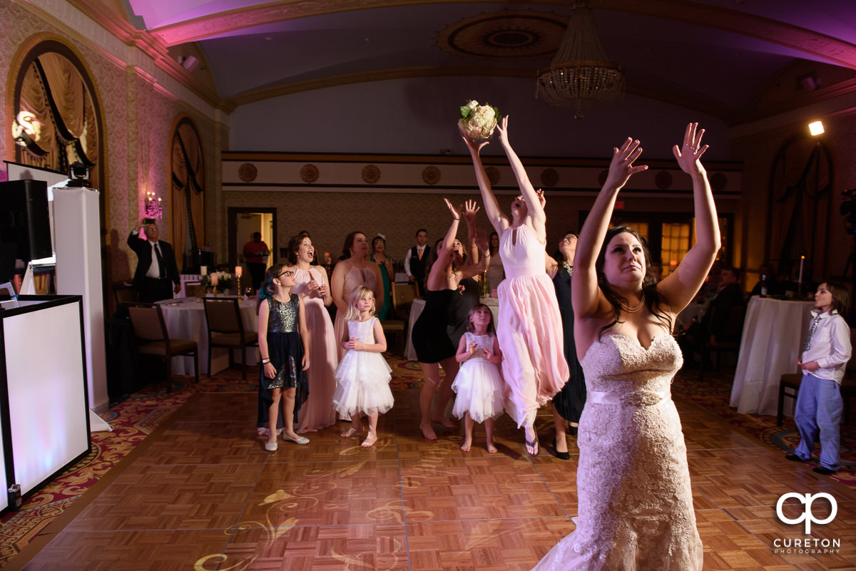 Bridesmaids catching the bouquet.