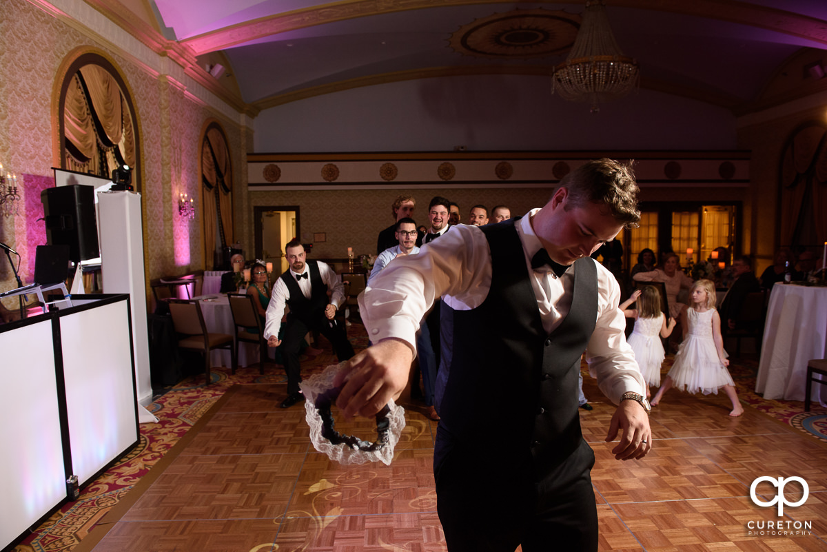 Groom tossing the garter.