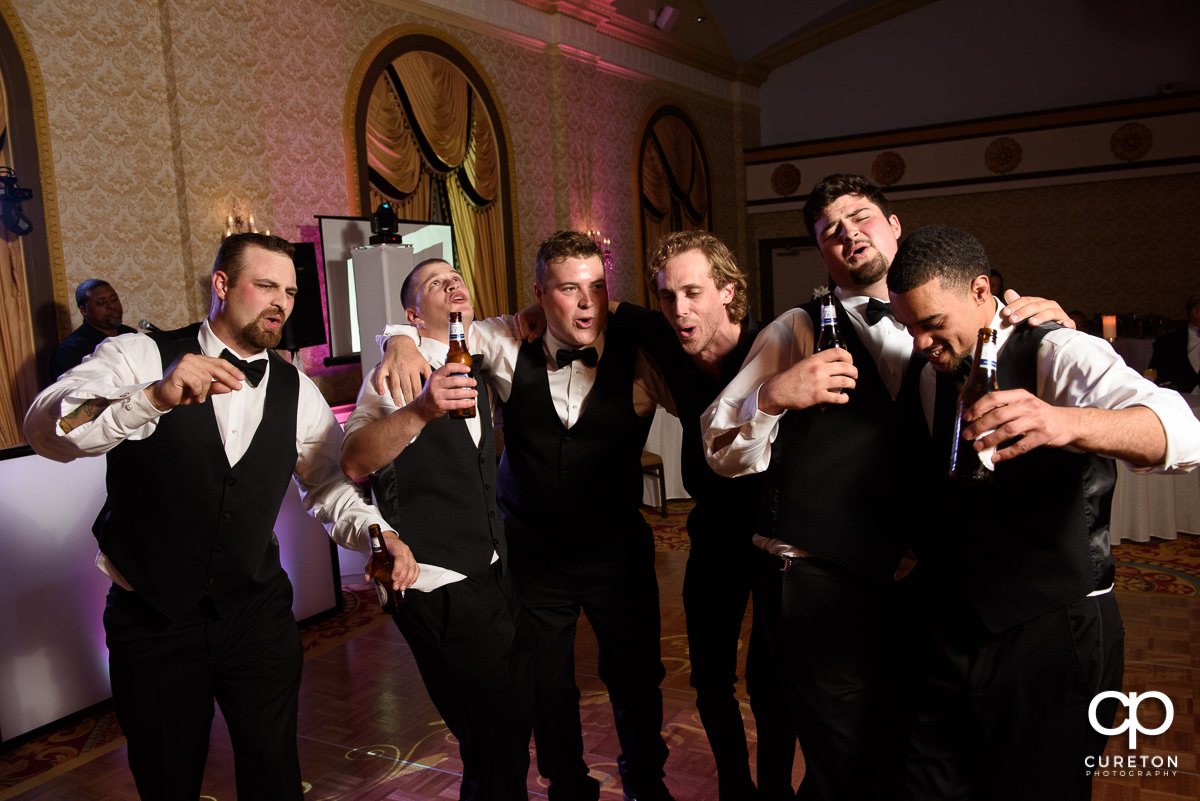 Groom and the groomsmen singing.