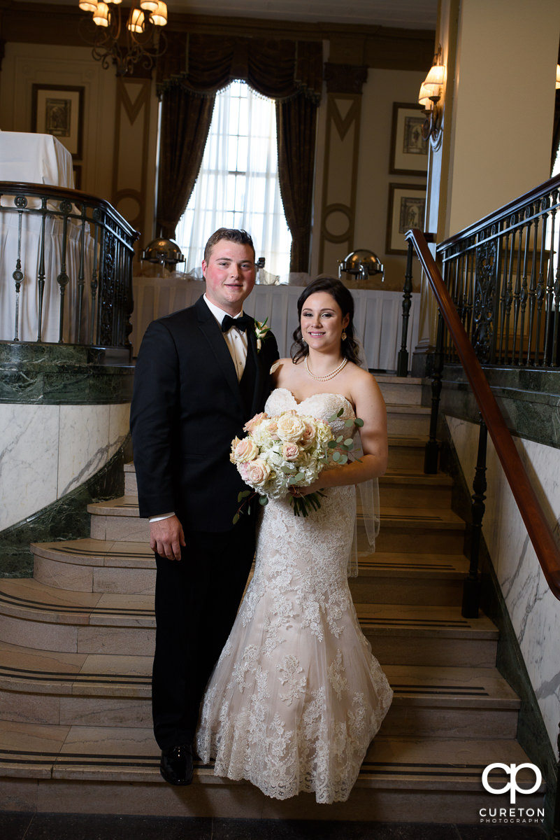 Bride and groom on the staircase at the Poinsett hotel.
