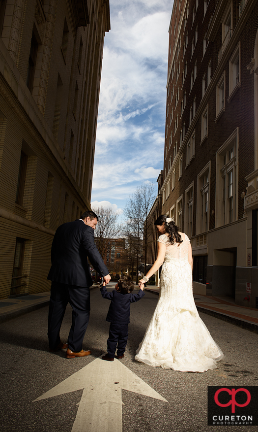 Bride and groom with their young son in downtown Greenville,SC.