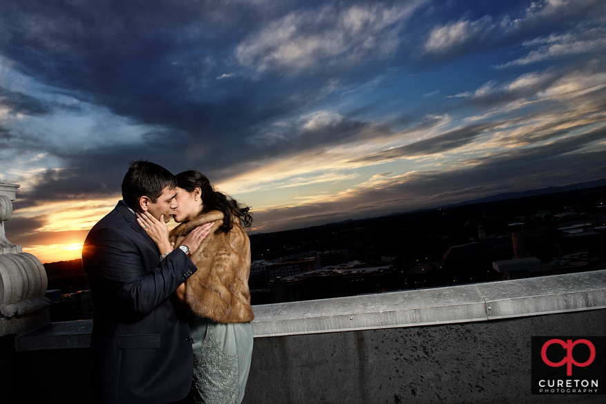Couple kissing on the roof of the Westin POinsett.