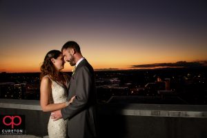 Bride and groom on the rooftop at sunset at their Westin Poinsett wedding.