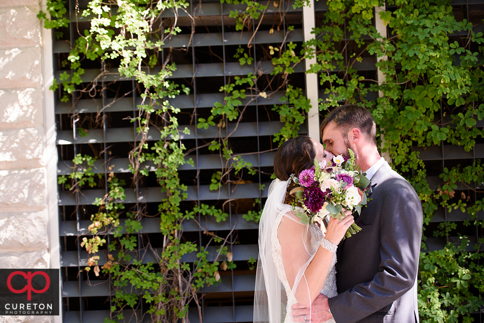 Bride and groom cuddling in downtown Greenville.